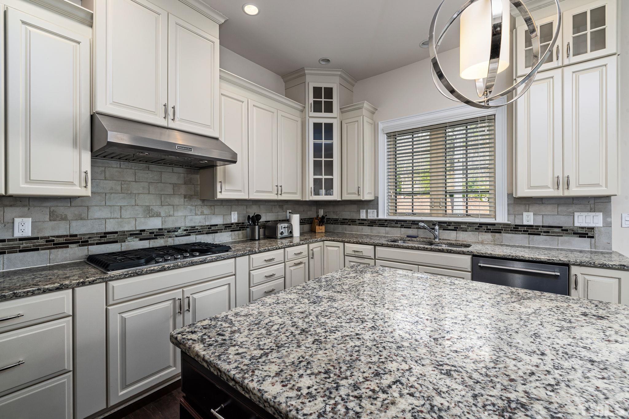 2808 Spring Shade Road Apex, NC 27523 - Photo 15 of 34 a kitchen with stainless steel appliances granite countertop a stove a sink and a white wooden cabinets