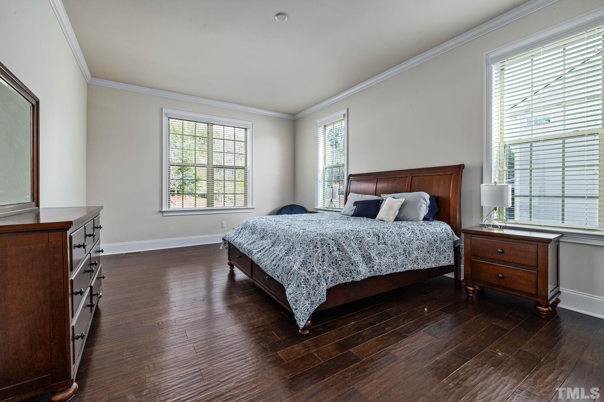 2808 Spring Shade Road Apex, NC 27523 - Photo 18 of 34 a bedroom with a bed and wooden floor