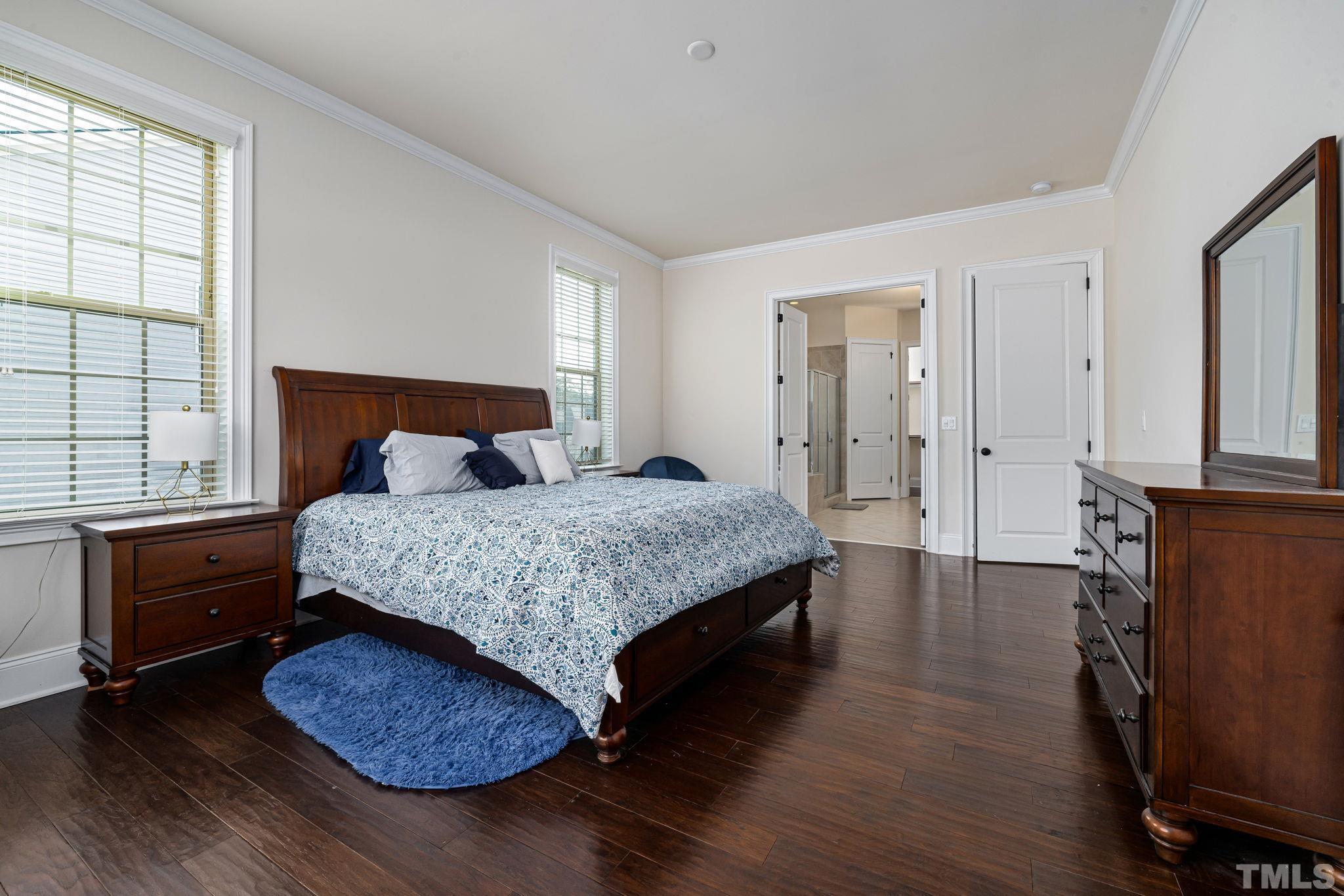 2808 Spring Shade Road Apex, NC 27523 - Photo 19 of 34 a bedroom with a bed and wooden floor