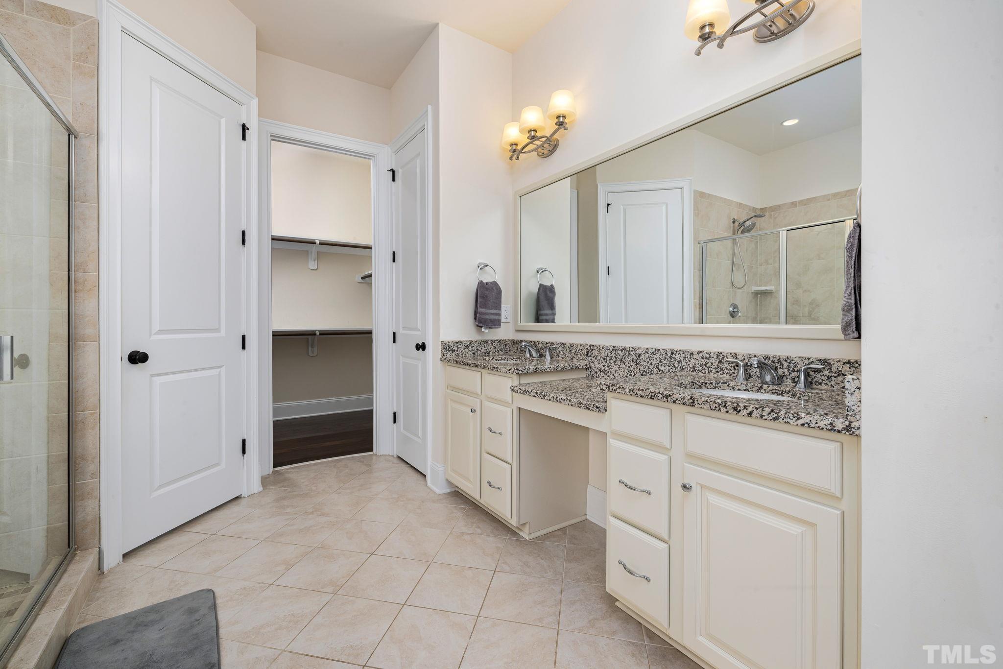 2808 Spring Shade Road Apex, NC 27523 - Photo 20 of 34 a bathroom with a granite countertop sink mirror and cabinets