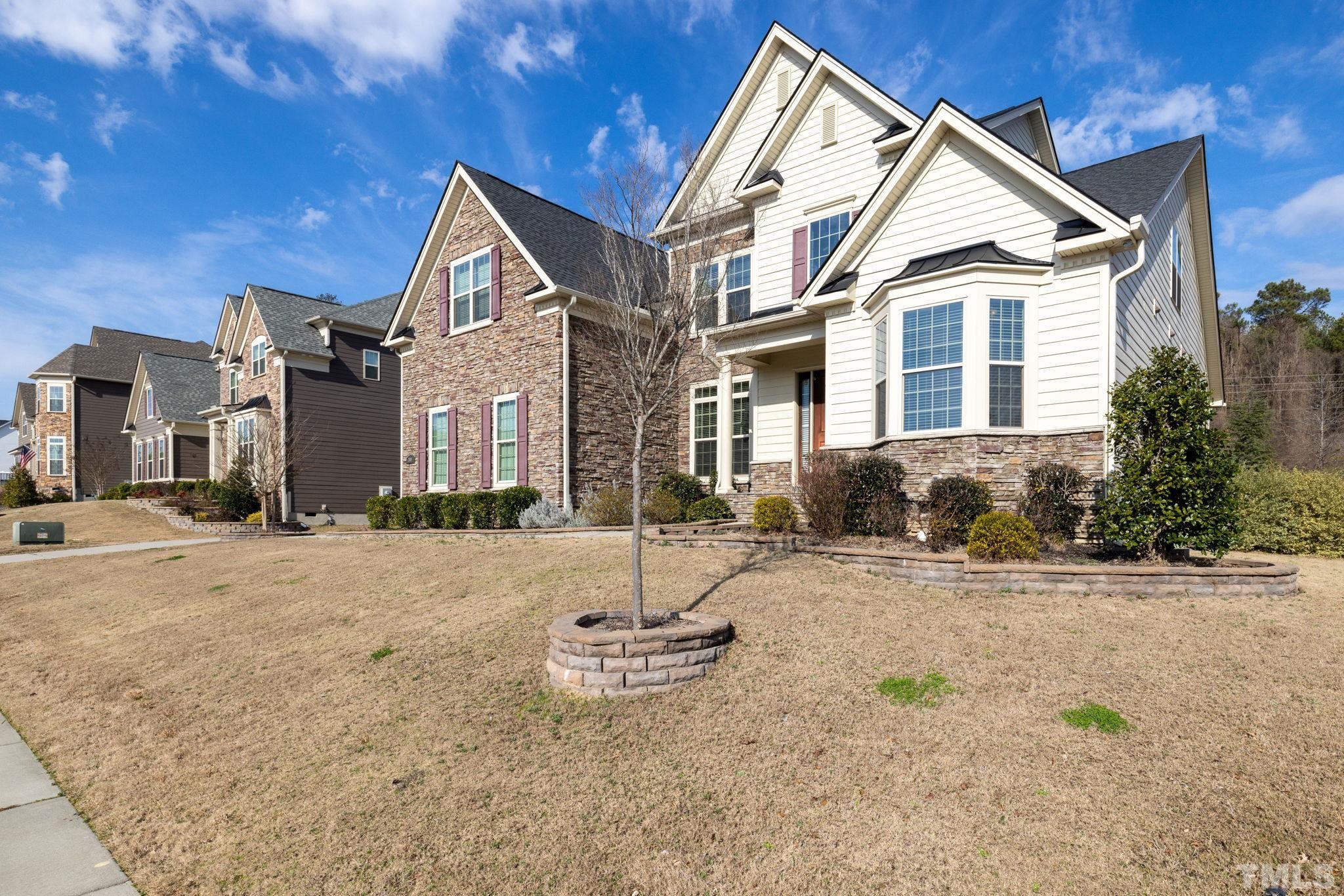 2808 Spring Shade Road Apex, NC 27523 - Photo 2 of 34 a view of a brick house with many windows next to a road