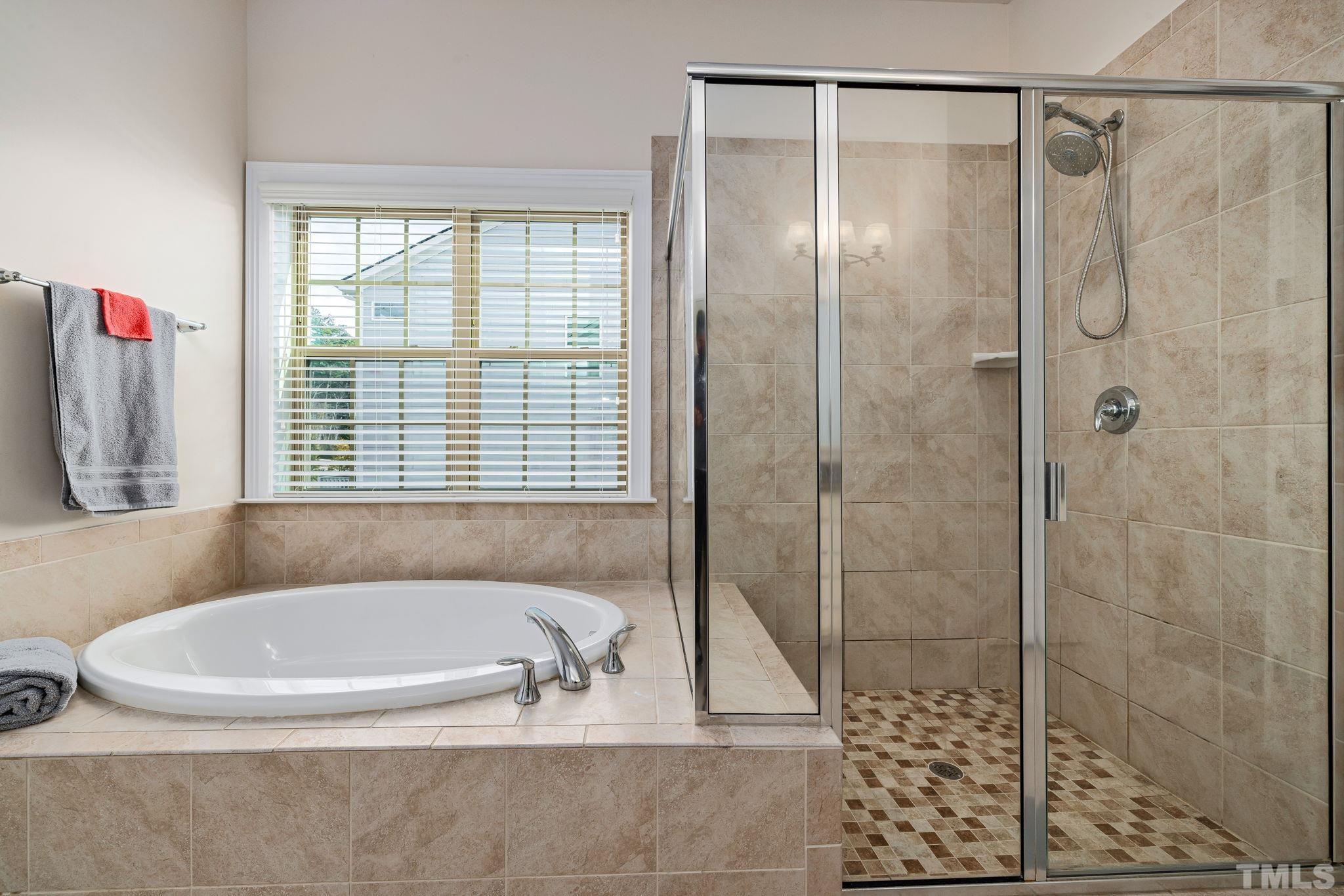 2808 Spring Shade Road Apex, NC 27523 - Photo 21 of 34 a bathroom with a bathtub and a shower