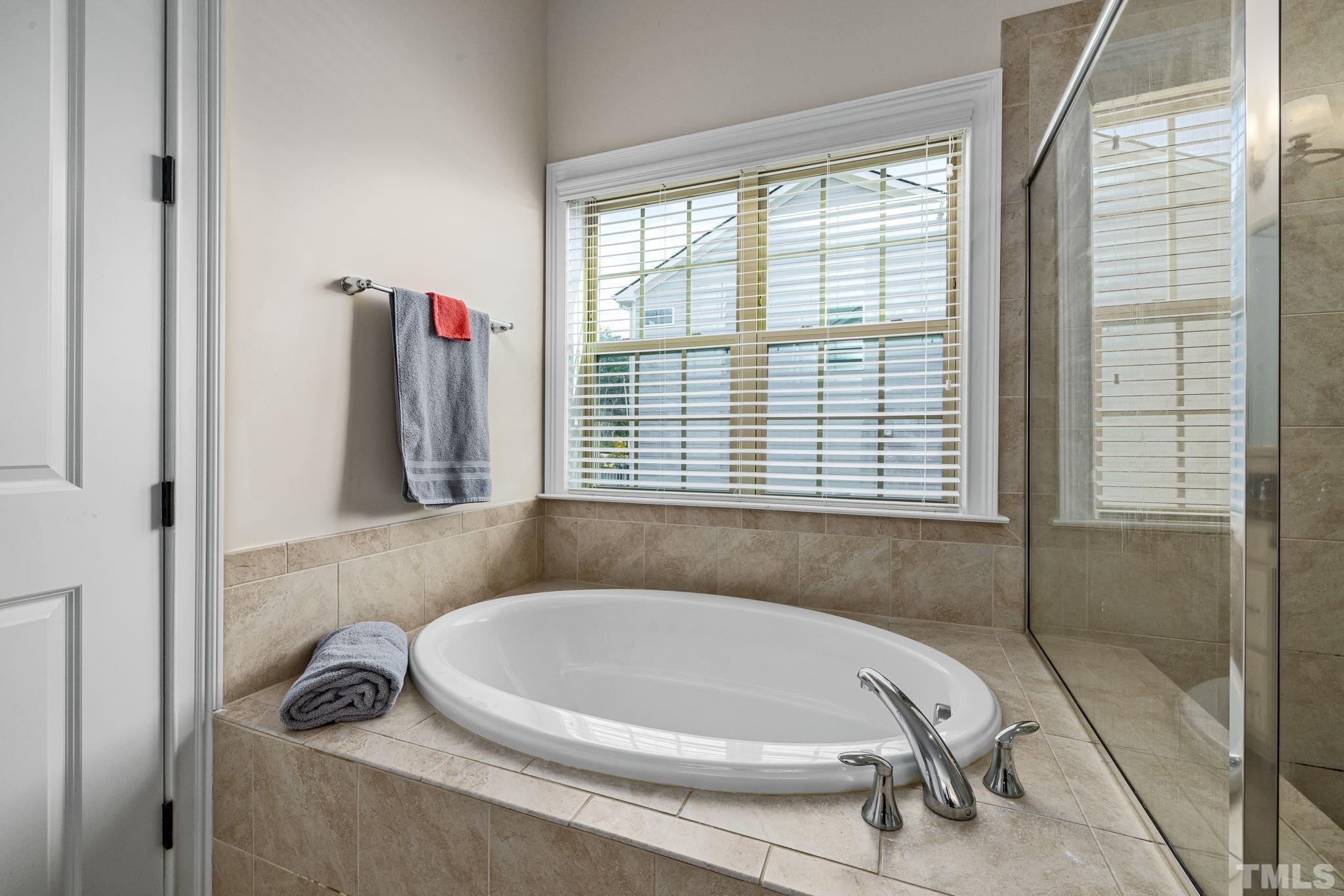 2808 Spring Shade Road Apex, NC 27523 - Photo 22 of 34 a bathroom with a bathtub and a window