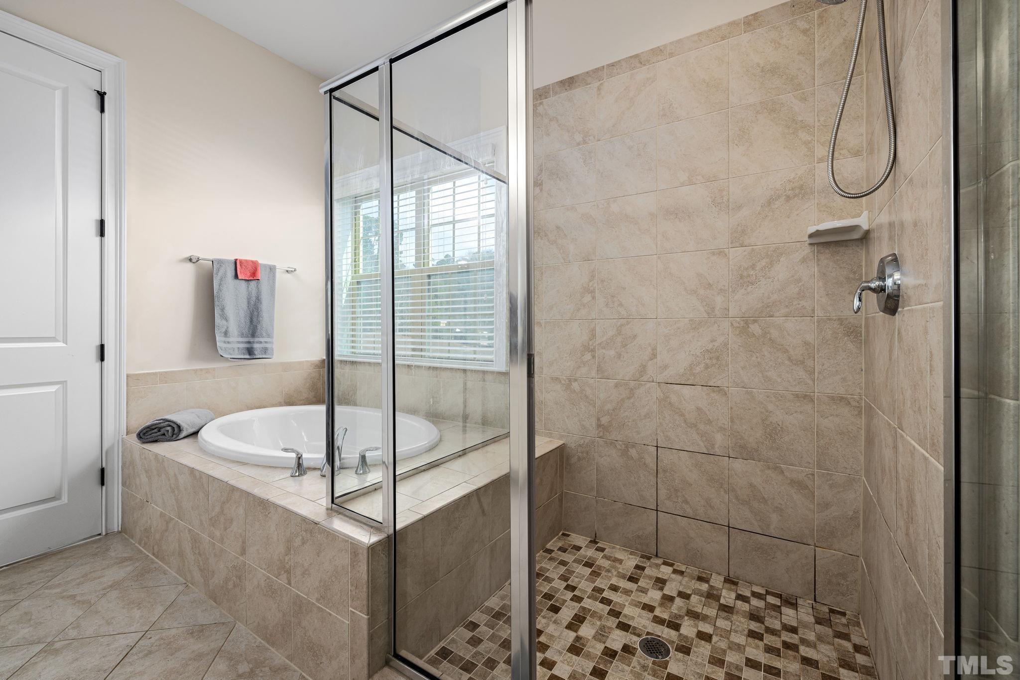 2808 Spring Shade Road Apex, NC 27523 - Photo 23 of 34 a bathroom with a bathtub and a shower