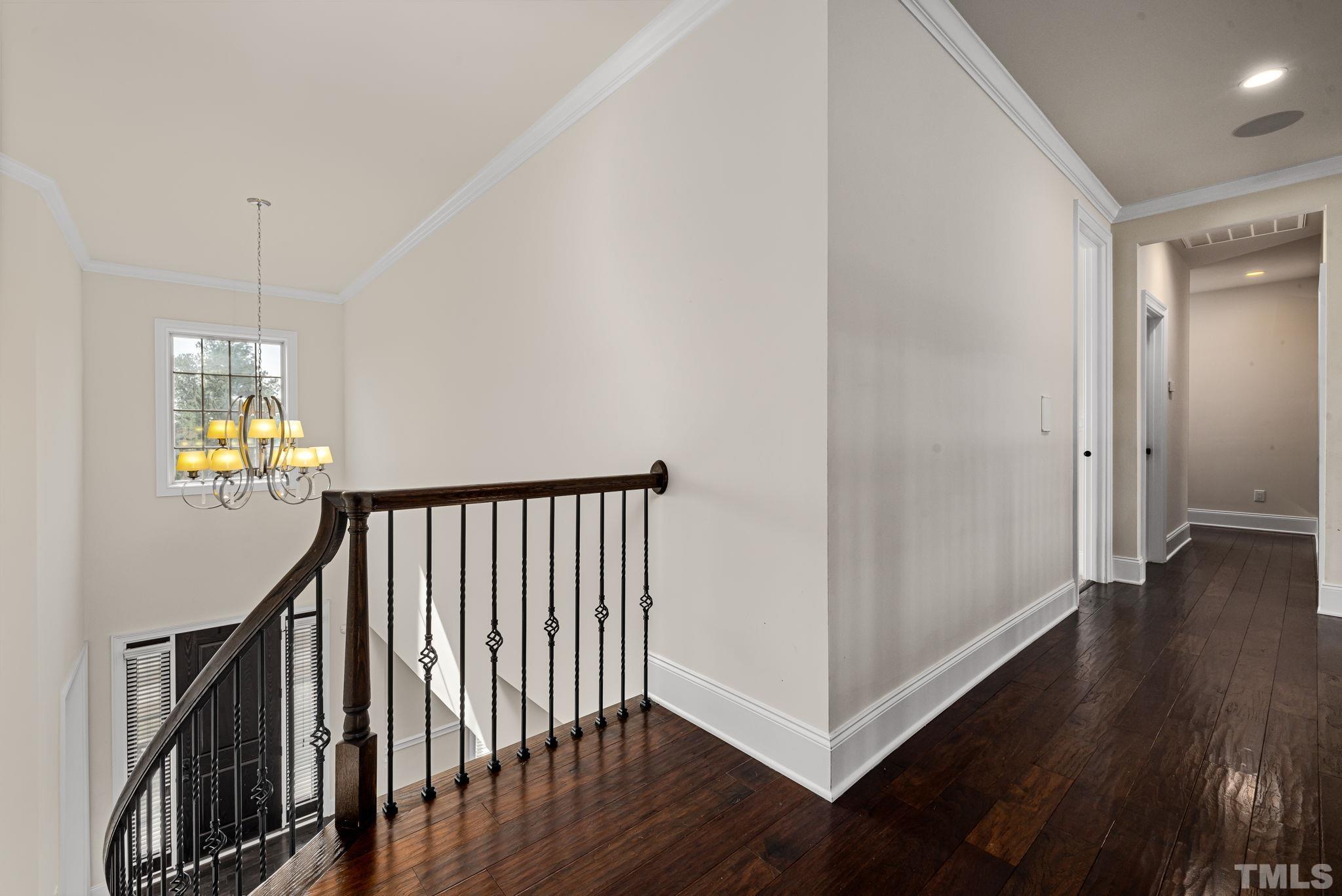 2808 Spring Shade Road Apex, NC 27523 - Photo 25 of 34 a view of a hallway with wooden floor and stairs