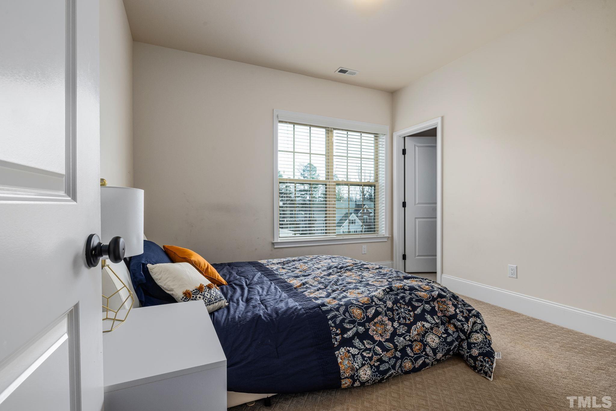 2808 Spring Shade Road Apex, NC 27523 - Photo 26 of 34 a bed sitting in a bedroom next to a window