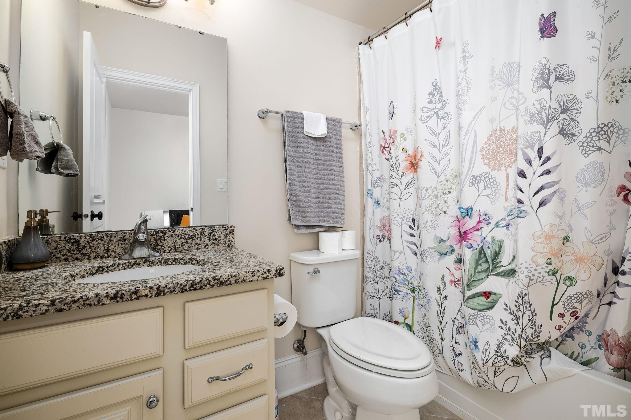 2808 Spring Shade Road Apex, NC 27523 - Photo 27 of 34 a bathroom with a granite countertop toilet sink and mirror