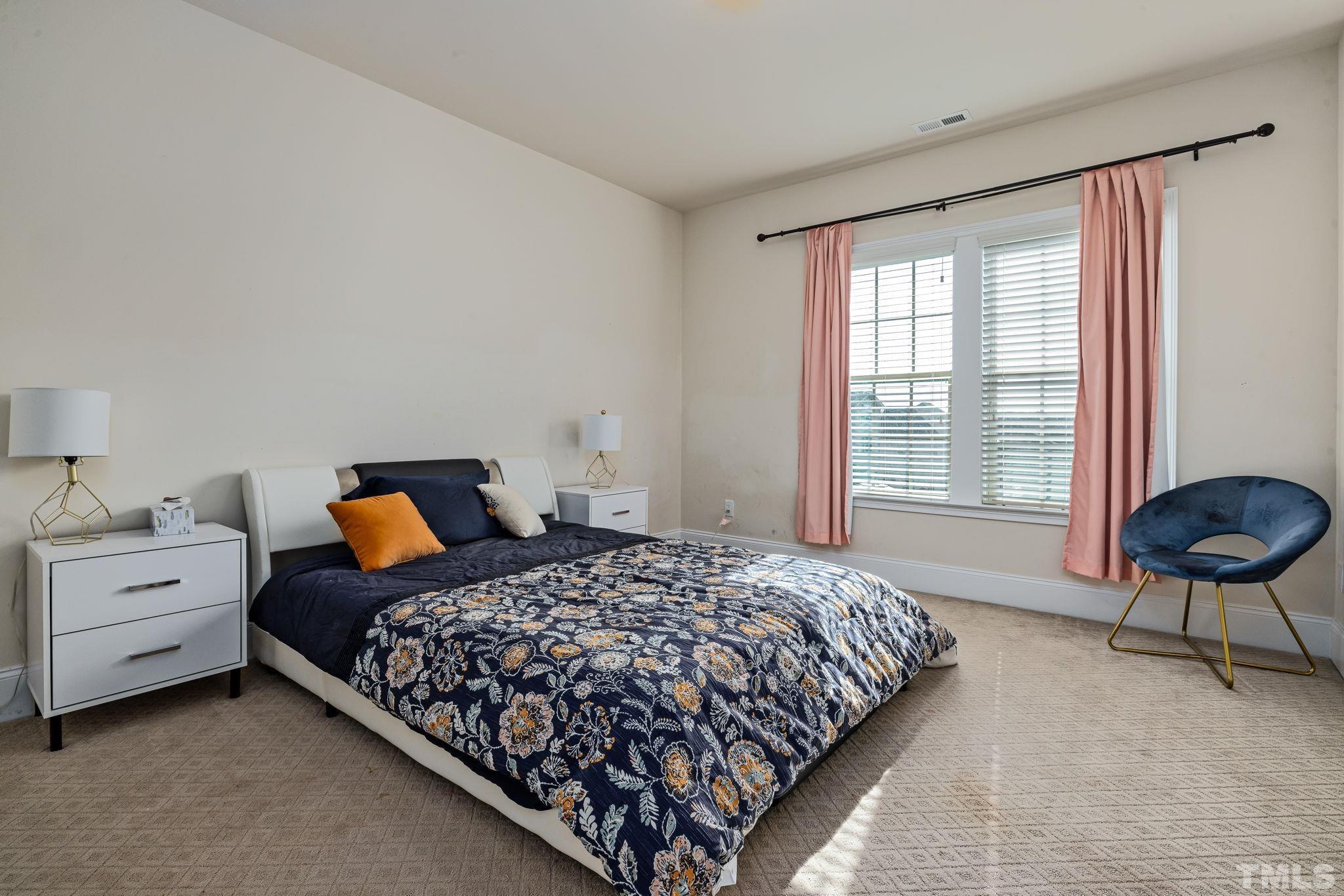 2808 Spring Shade Road Apex, NC 27523 - Photo 28 of 34 a bedroom with a bed and a chair