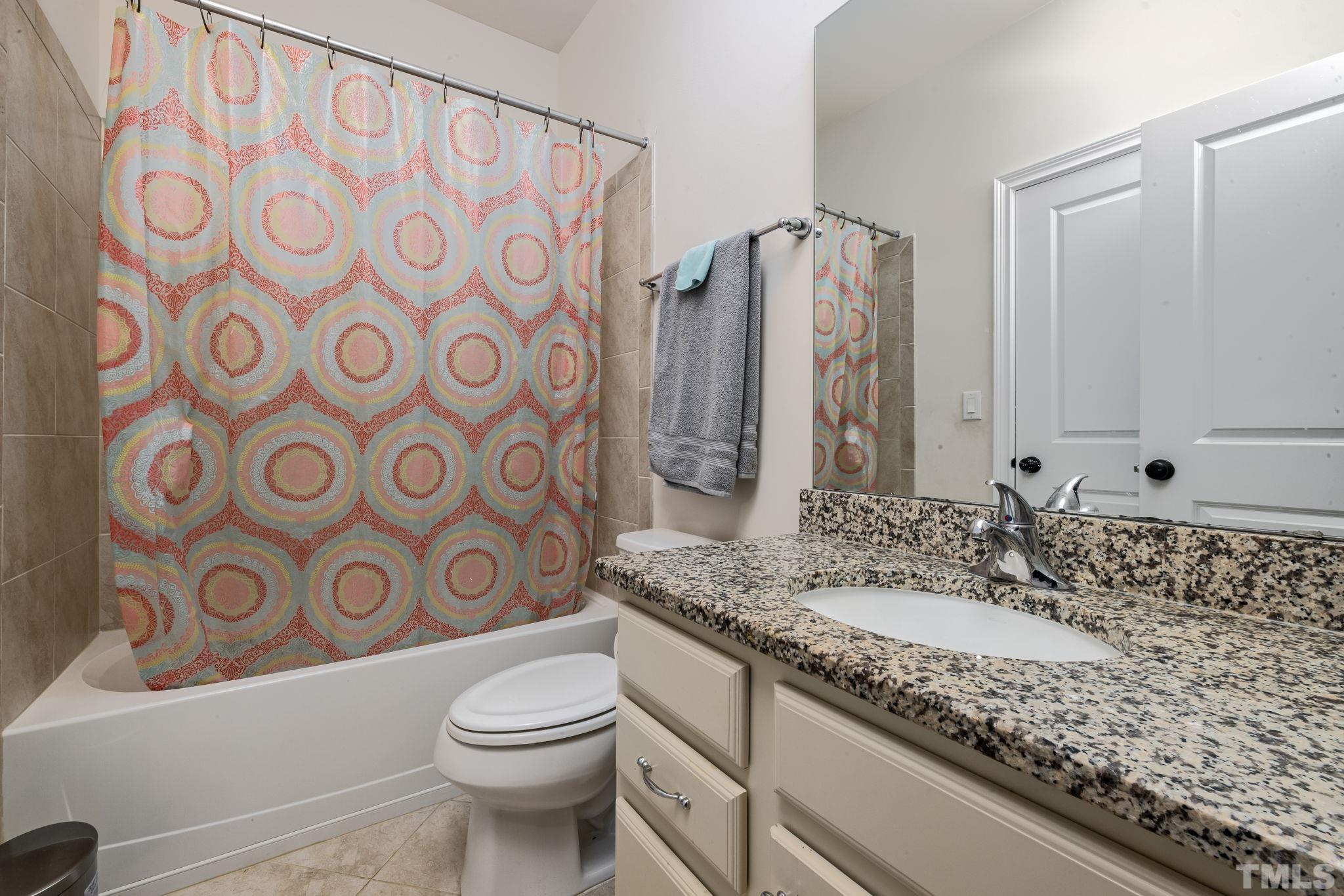 2808 Spring Shade Road Apex, NC 27523 - Photo 29 of 34 a bathroom with a granite countertop toilet sink and mirror
