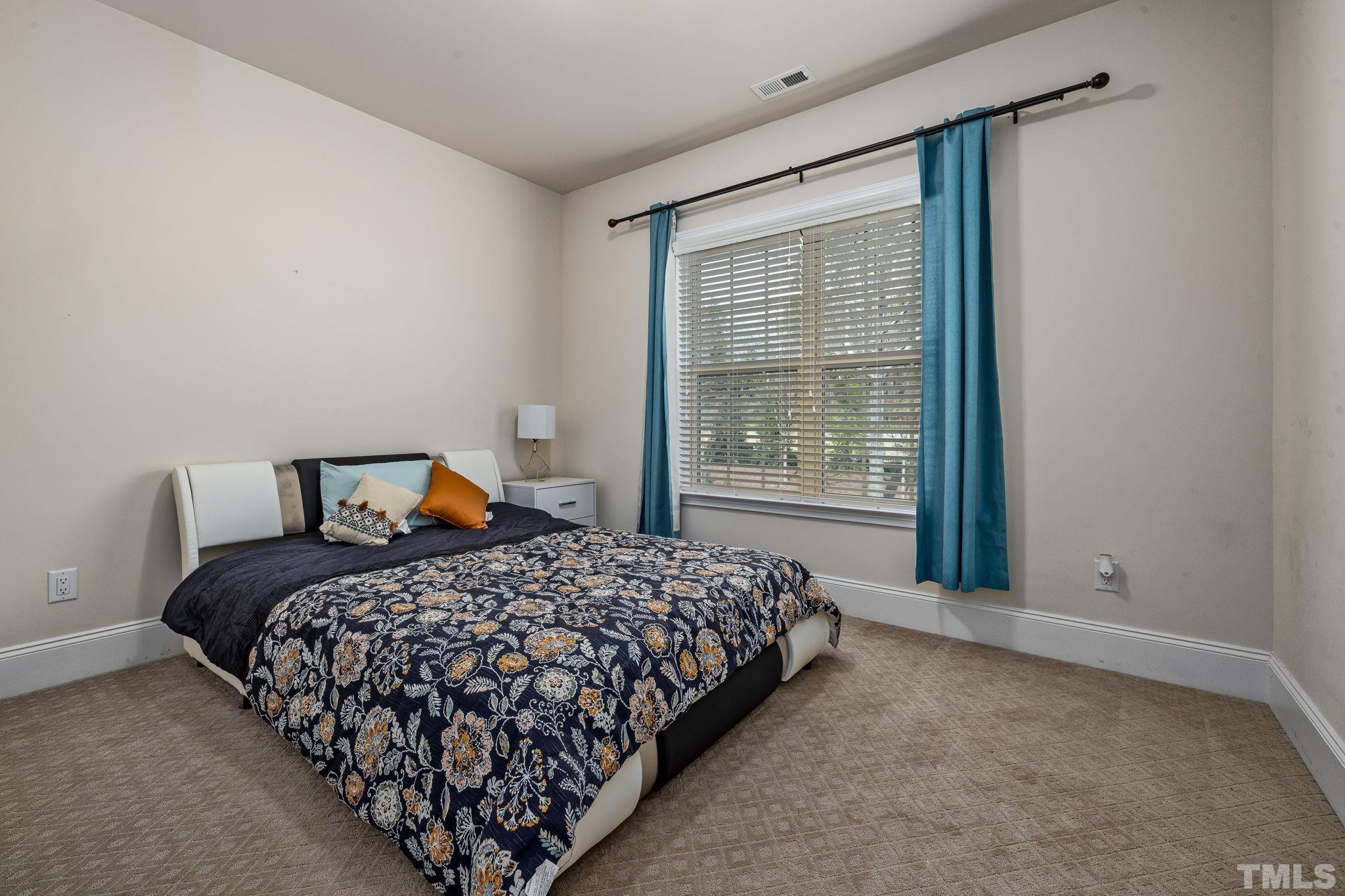 2808 Spring Shade Road Apex, NC 27523 - Photo 30 of 34 a bedroom with a bed and window