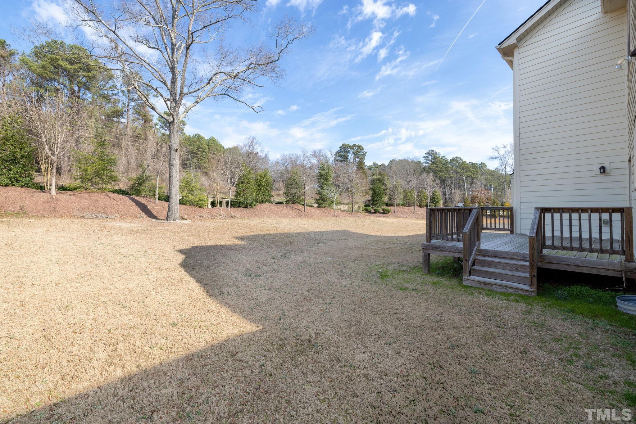 2808 Spring Shade Road Apex, NC 27523 - Photo 33 of 34 a backyard of a house with table and chairs