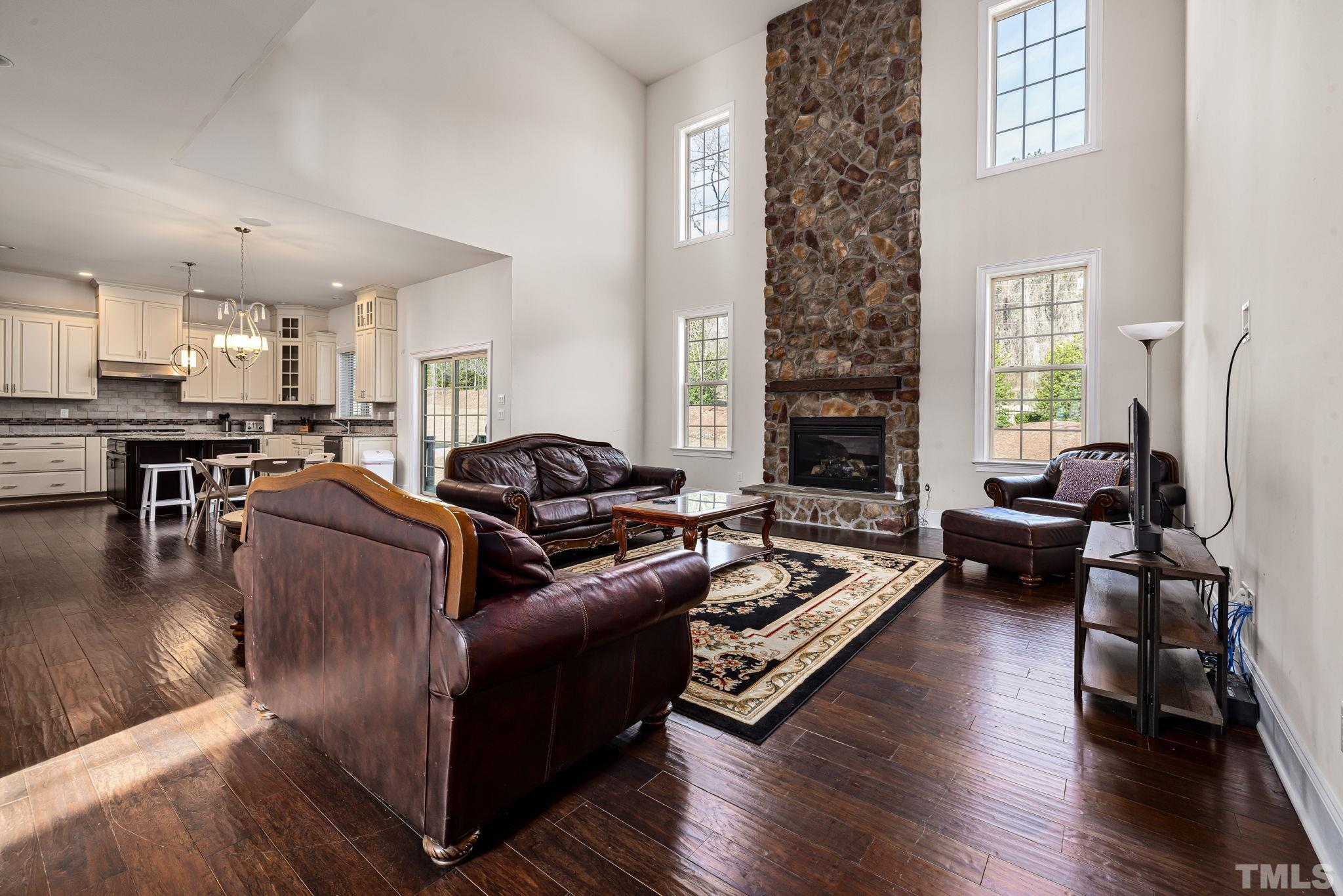 2808 Spring Shade Road Apex, NC 27523 - Photo 8 of 34 a living room with furniture or couch and a fireplace