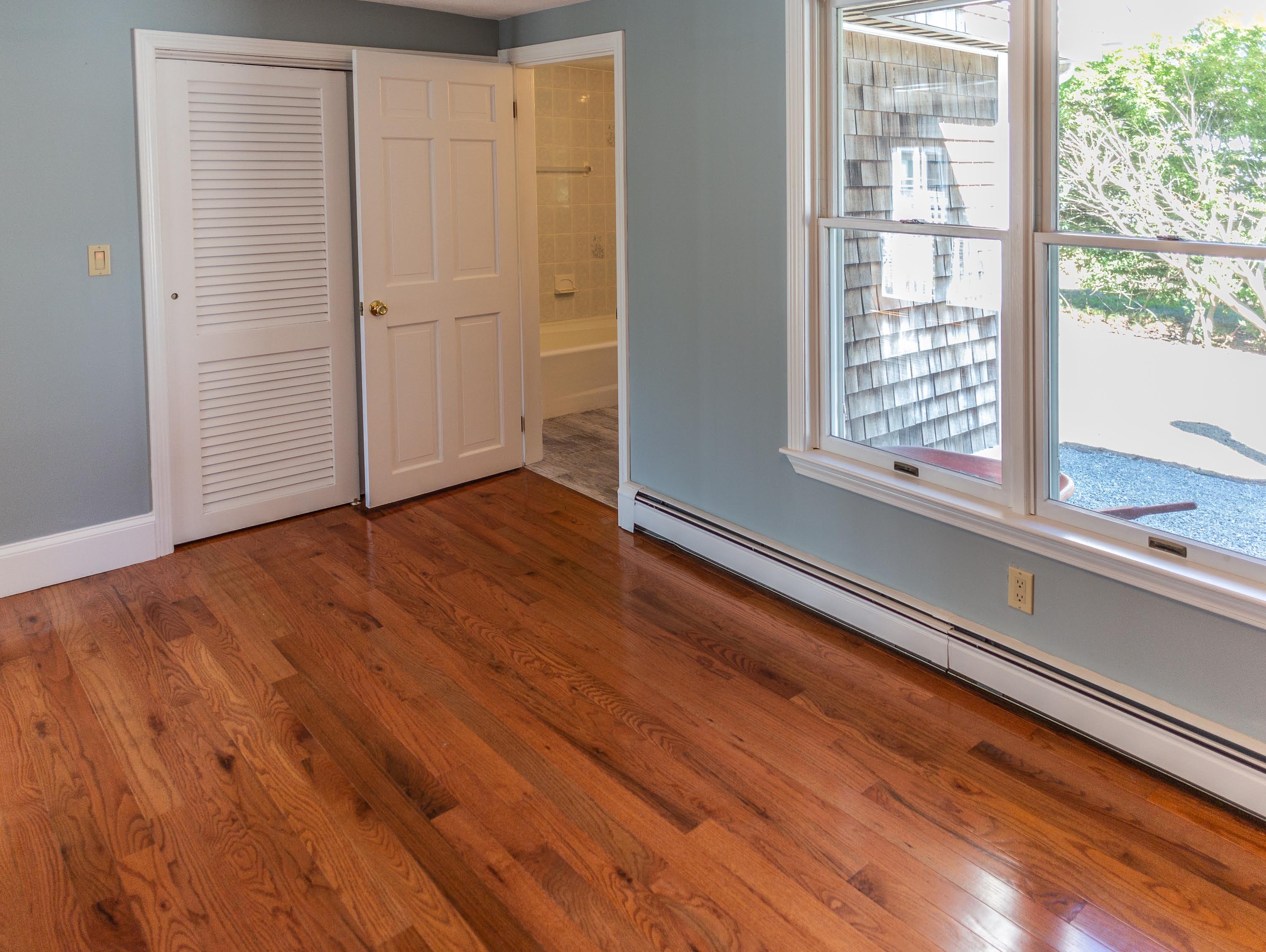 30 Carr Road Dennis Port, MA 02639 - Photo 11 of 26 an empty room with wooden floor and windows