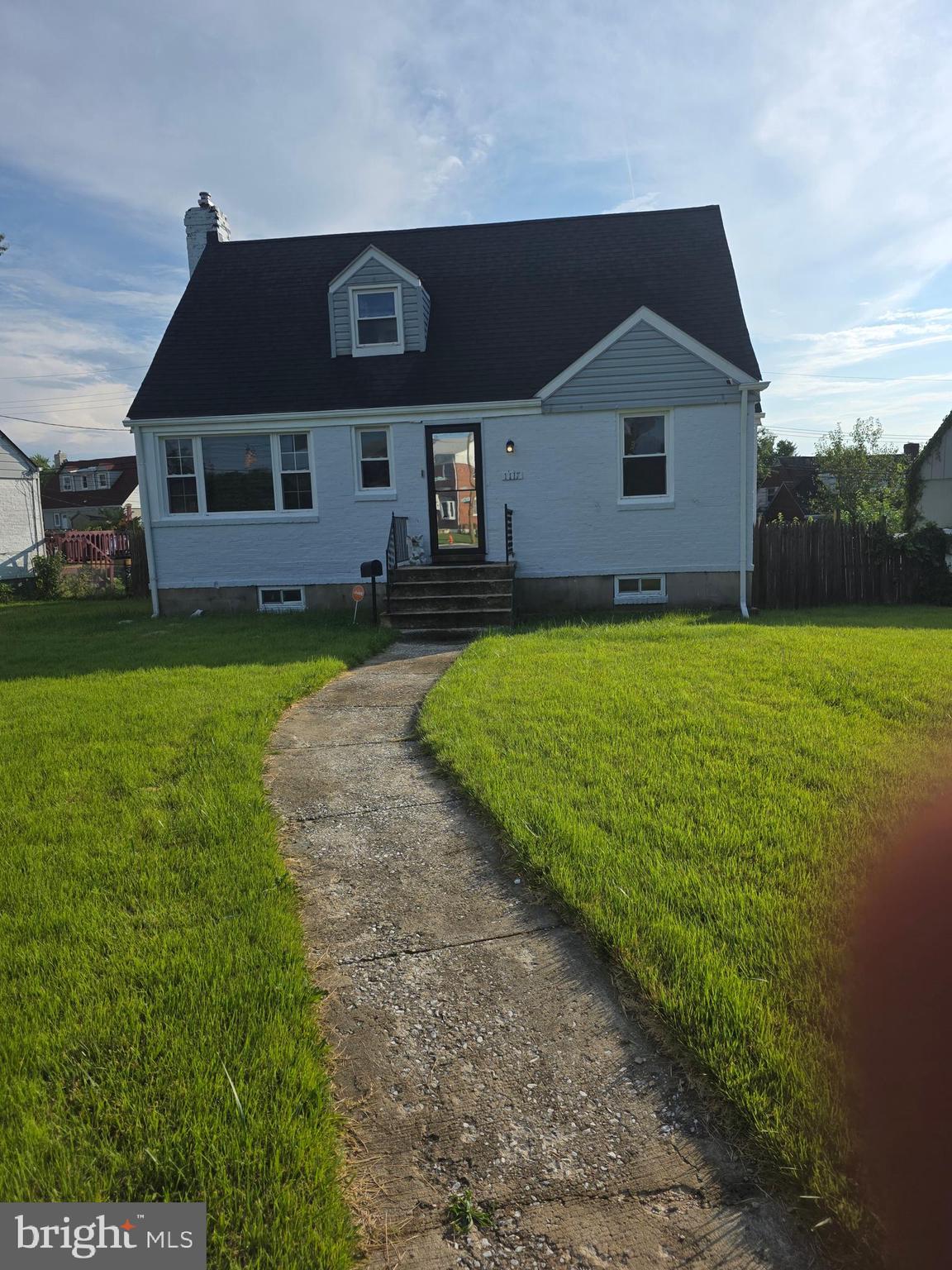 1117 Walker Avenue Baltimore, MD 21239 - Photo 2 of 16 a front view of a house with garden