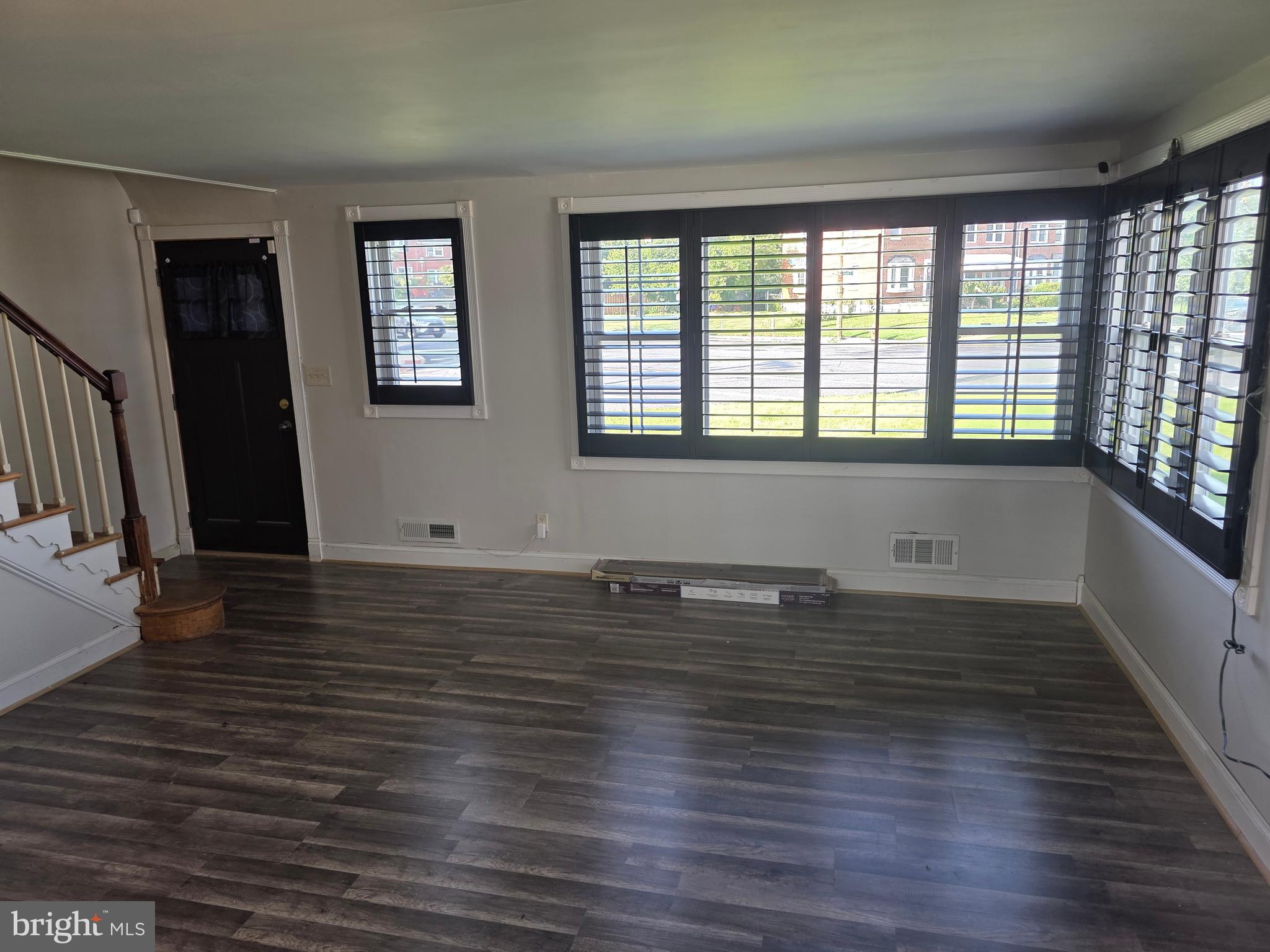 1117 Walker Avenue Baltimore, MD 21239 - Photo 3 of 16 a view of empty room with wooden floor and fan