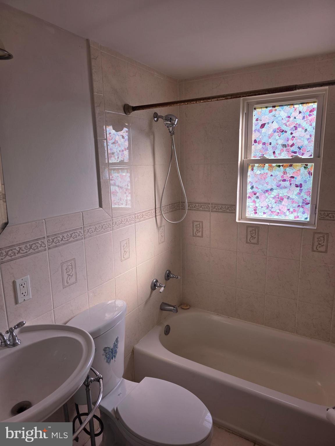1117 Walker Avenue Baltimore, MD 21239 - Photo 6 of 16 a bathroom with a tub a sink and a shower