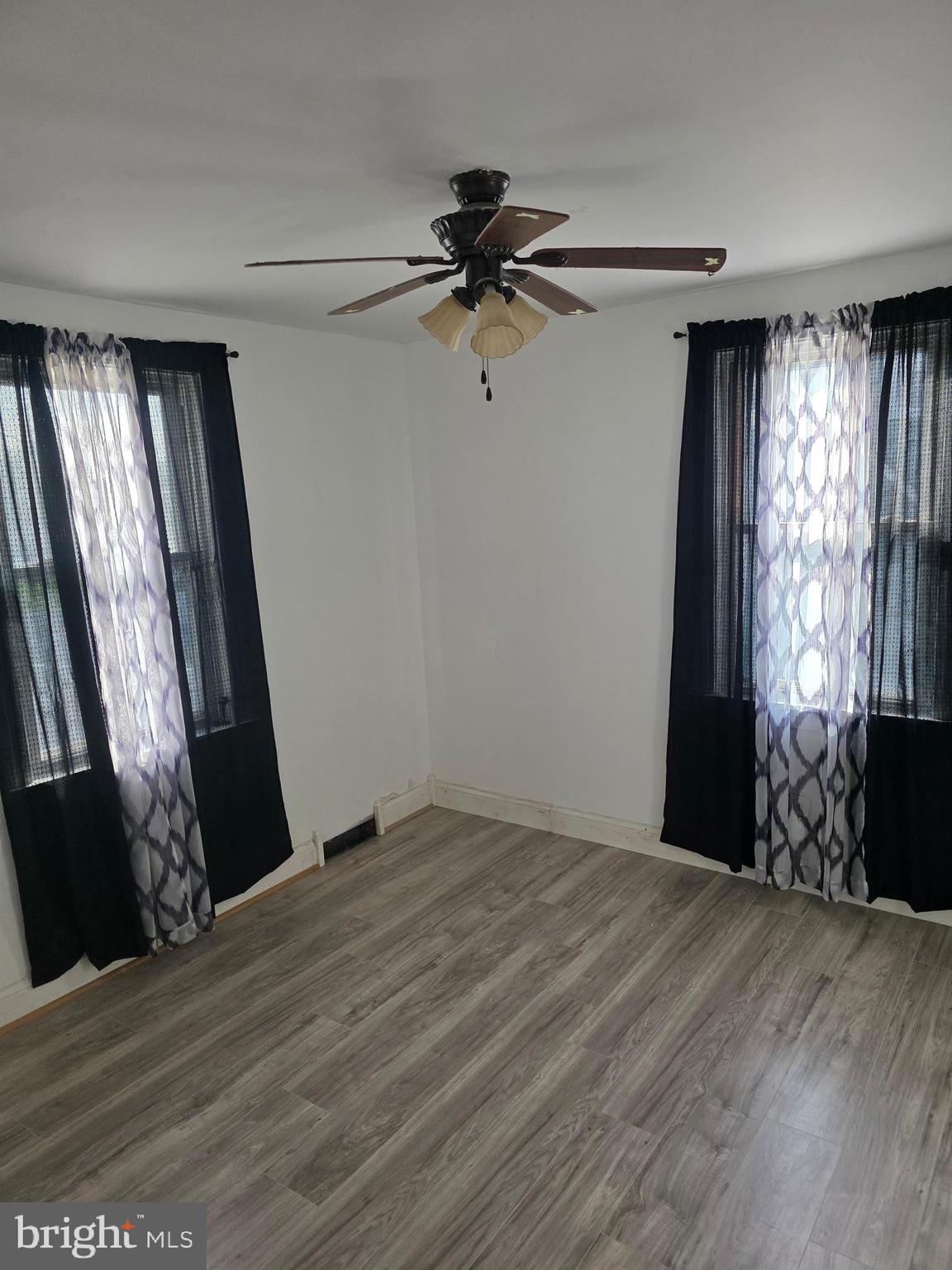 1117 Walker Avenue Baltimore, MD 21239 - Photo 7 of 16 a view of a livingroom with a window and hardwood floor