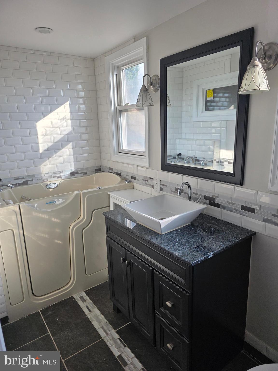 1117 Walker Avenue Baltimore, MD 21239 - Photo 10 of 16 a sink with view of washer and dryer
