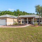 a view of a house with a yard and sitting area