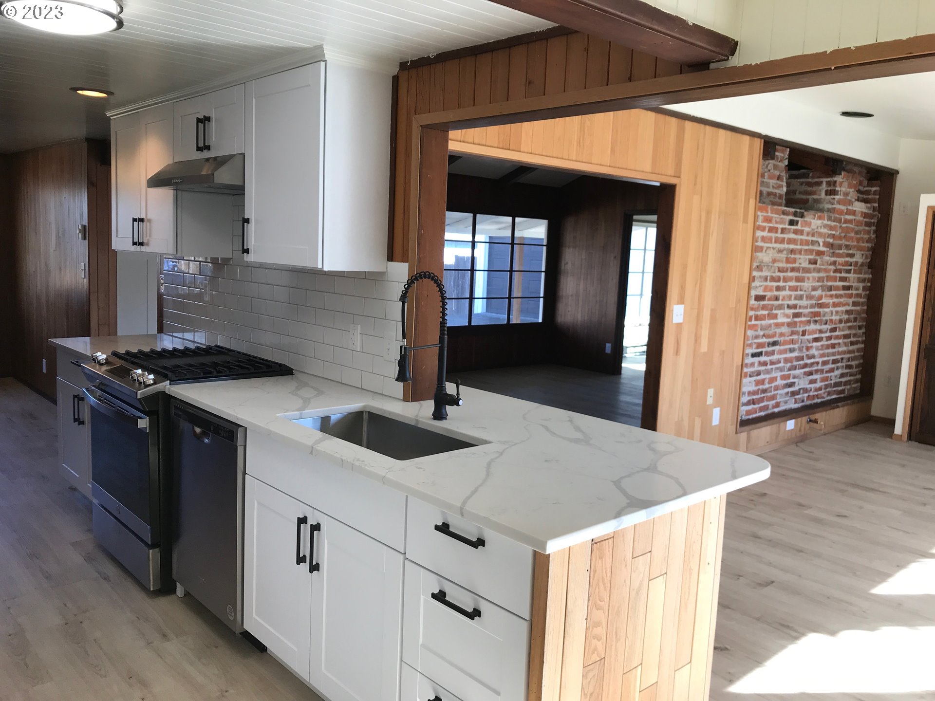 2295 Dakota Street Eugene, OR 97402 - Photo 3 of 17 a kitchen with granite countertop a sink a stove and cabinets