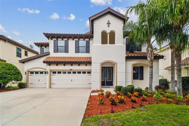 a view of a hallway with windows and chandelier