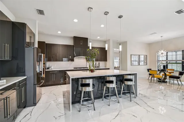 a dining room with furniture and view of kitchen