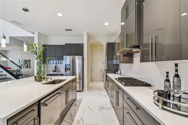 a bedroom with a large bed and a chandelier