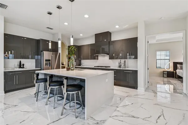 a large bathroom with a granite countertop double vanity sink a mirror and a bathtub