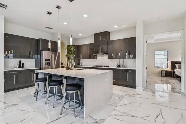 a large bathroom with a granite countertop double vanity sink a mirror and a bathtub