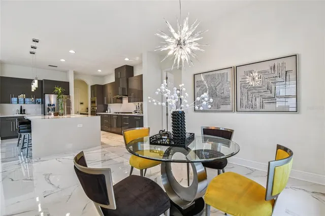 a living room with patio furniture and a floor to ceiling window