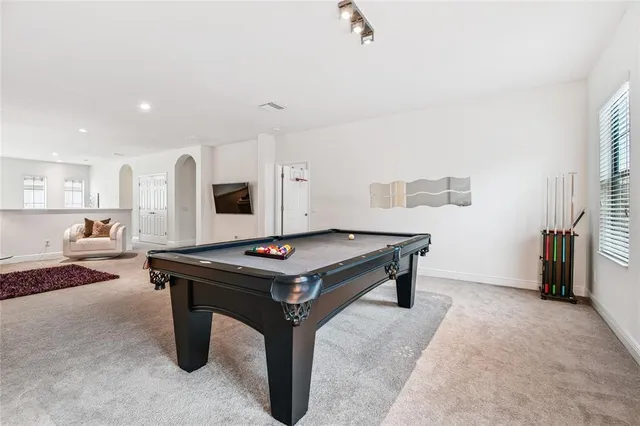 a living room with furniture a rug and a window