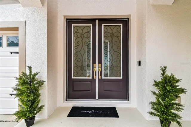 a kitchen with stainless steel appliances kitchen island granite countertop a table chairs and a refrigerator