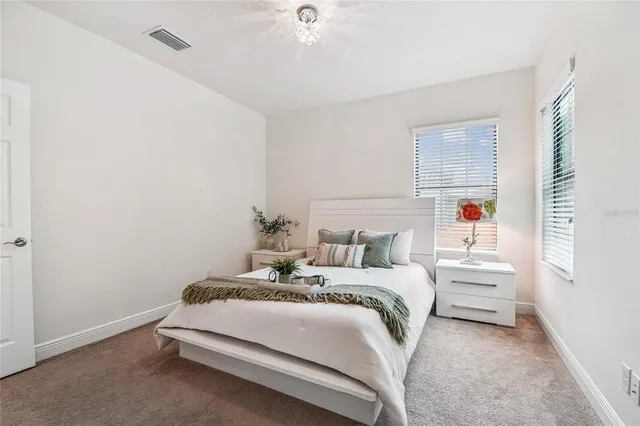 an aerial view of a house with table and chairs and wooden fence
