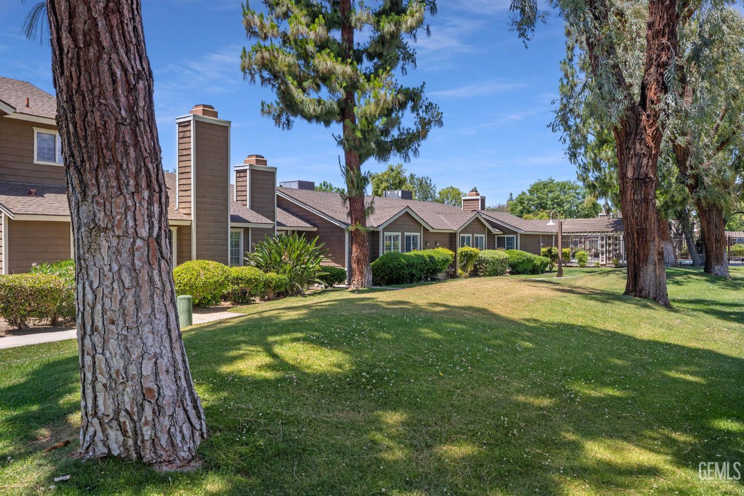 Undisclosed Address Bakersfield, CA 93309 - Photo 1 of 42 a view of a house with a tree in a yard