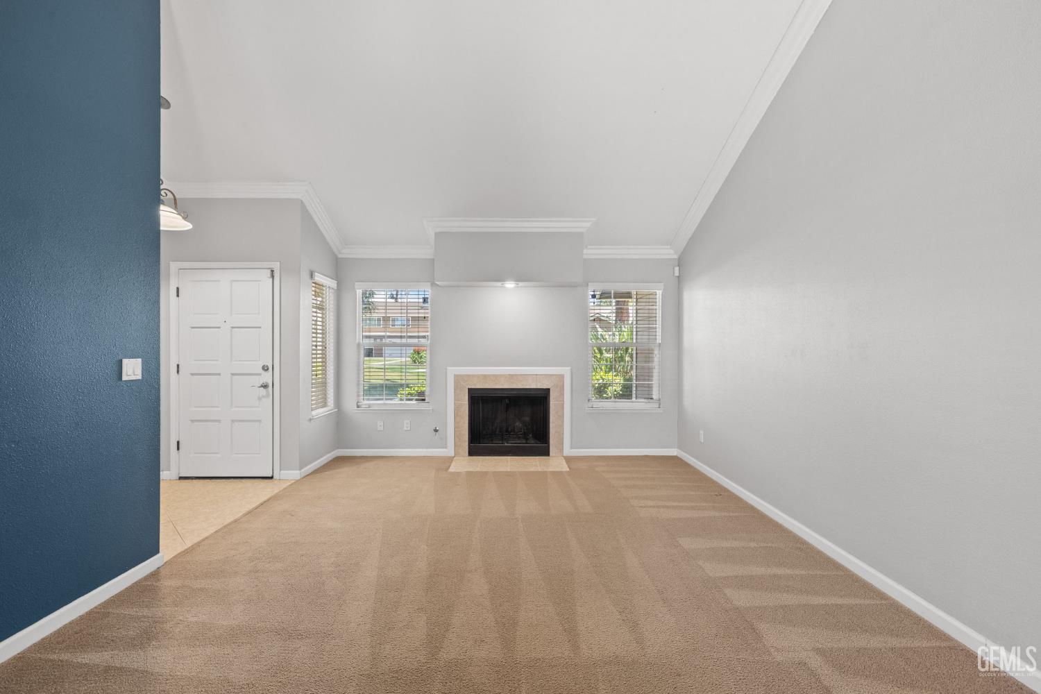 Undisclosed Address Bakersfield, CA 93309 - Photo 11 of 42 an empty room with windows and fireplace