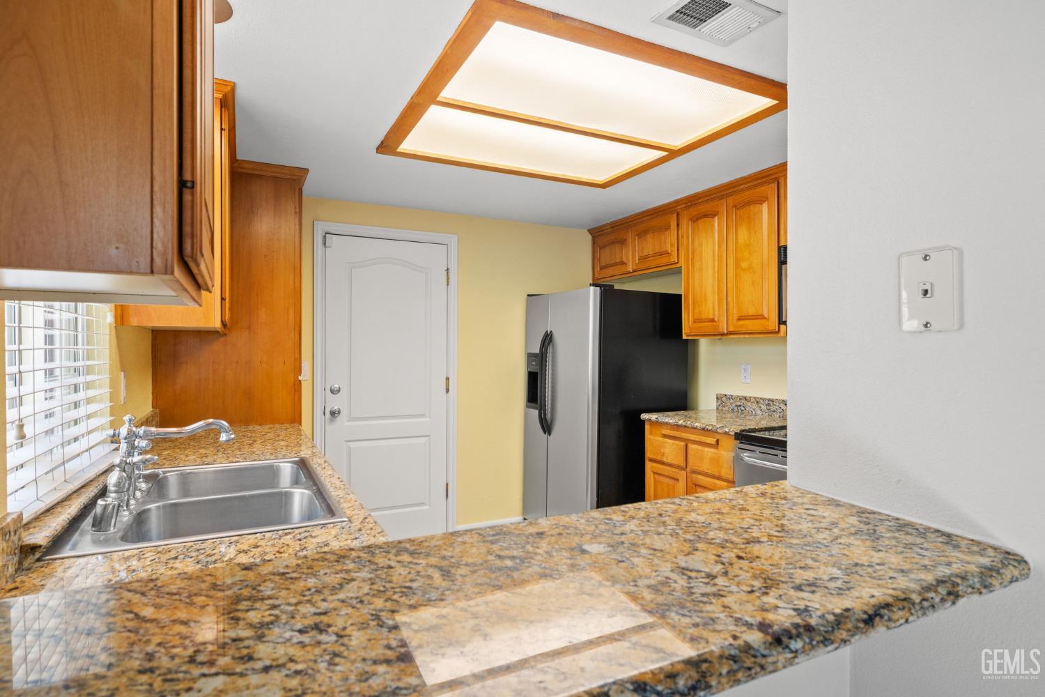 Undisclosed Address Bakersfield, CA 93309 - Photo 20 of 42 a bedroom with a bed and wooden floor