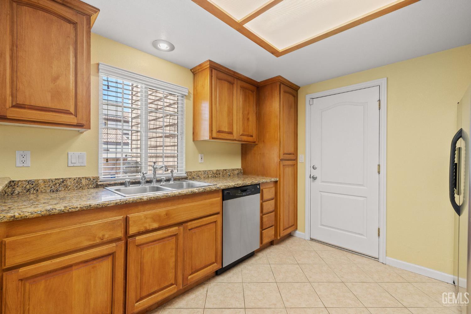 Undisclosed Address Bakersfield, CA 93309 - Photo 21 of 42 a kitchen with granite countertop cabinets and window