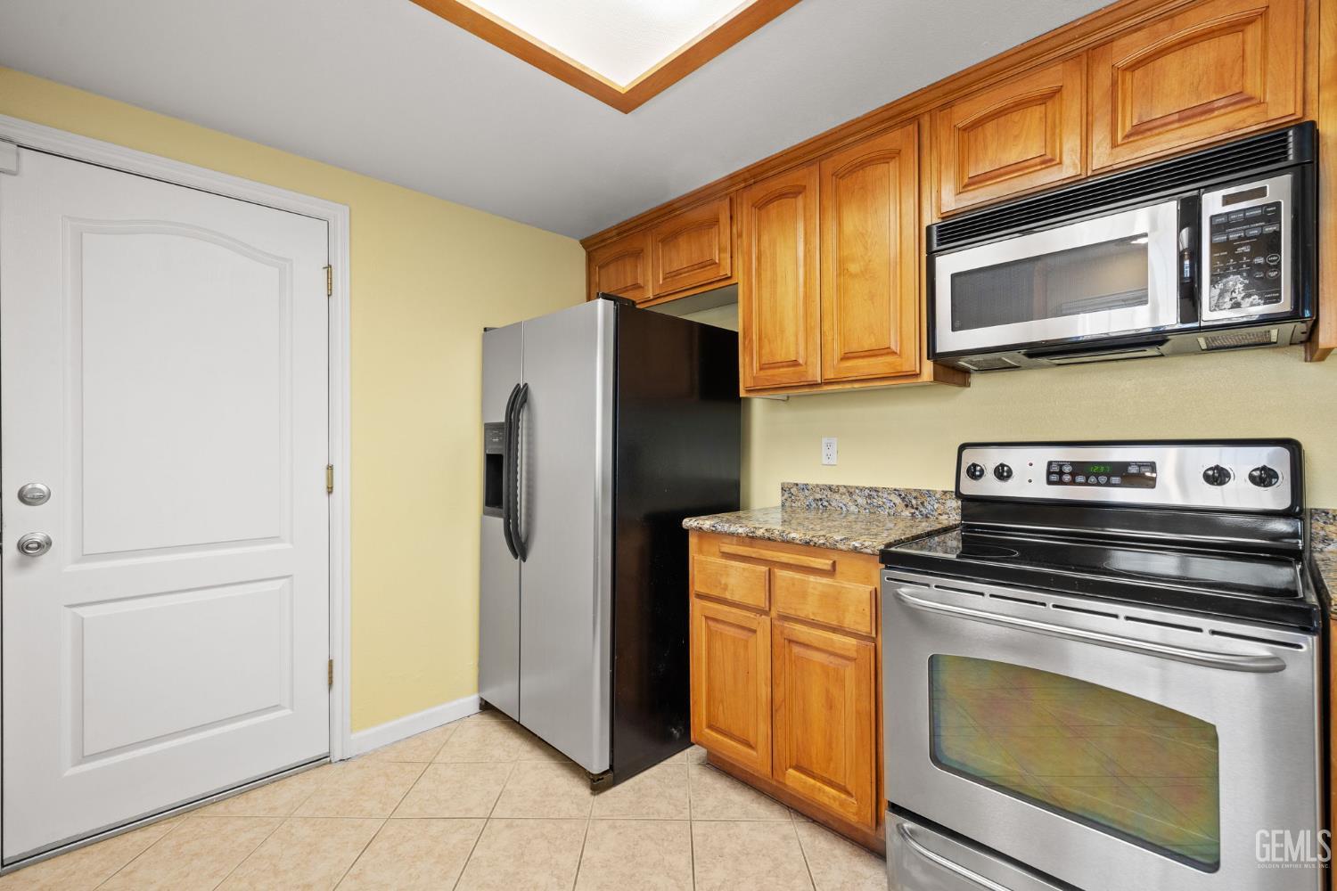 Undisclosed Address Bakersfield, CA 93309 - Photo 22 of 42 a kitchen with a stove microwave and refrigerator