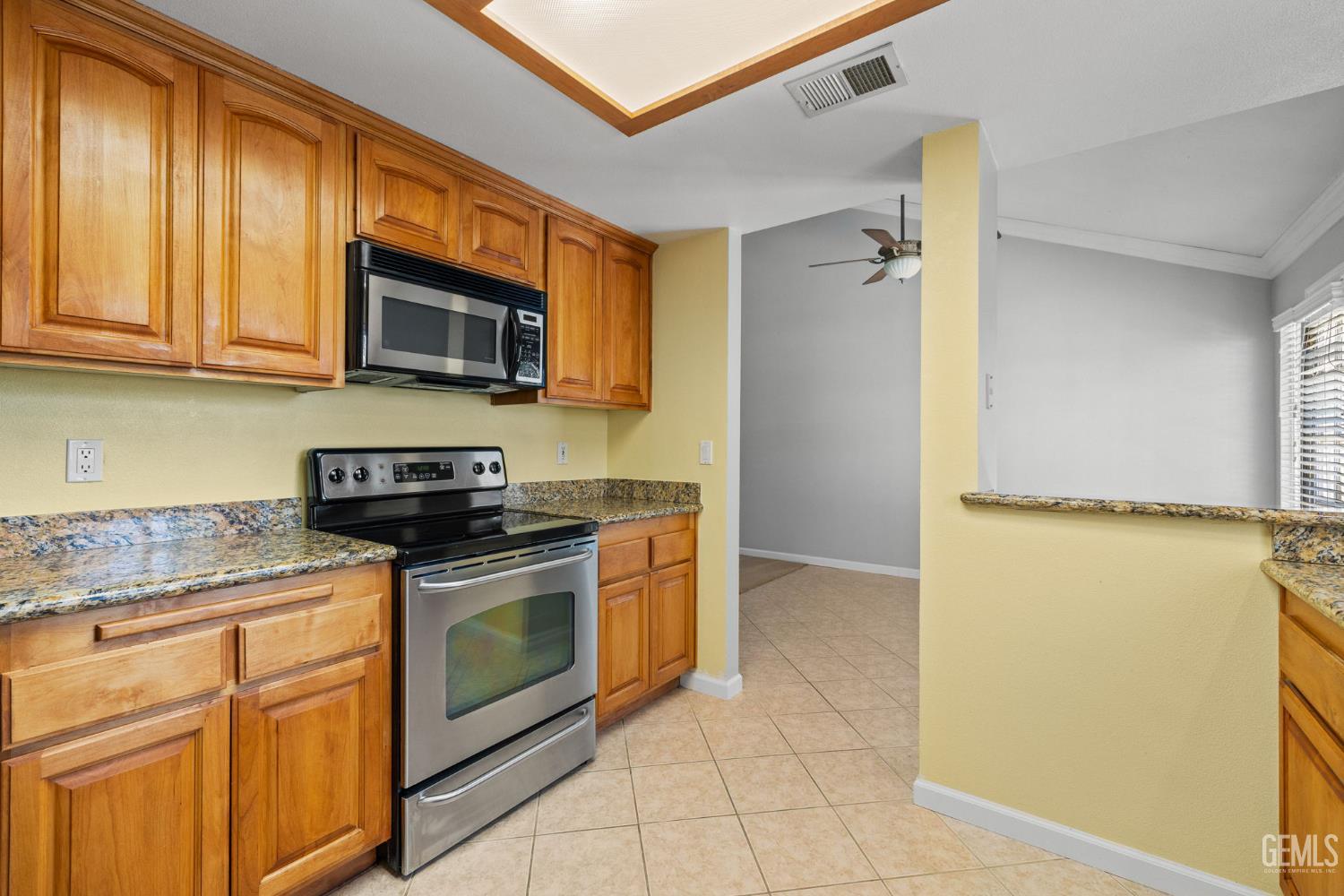 Undisclosed Address Bakersfield, CA 93309 - Photo 25 of 42 a kitchen with stainless steel appliances granite countertop a stove a sink and a microwave