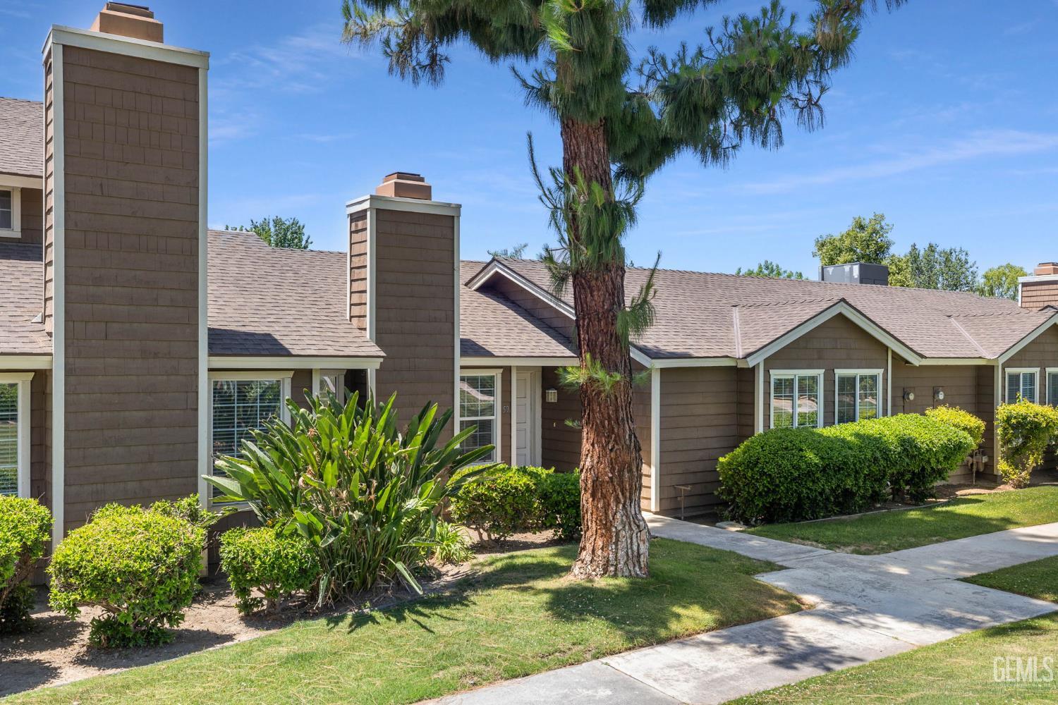 Undisclosed Address Bakersfield, CA 93309 - Photo 3 of 42 a front view of a house with garden