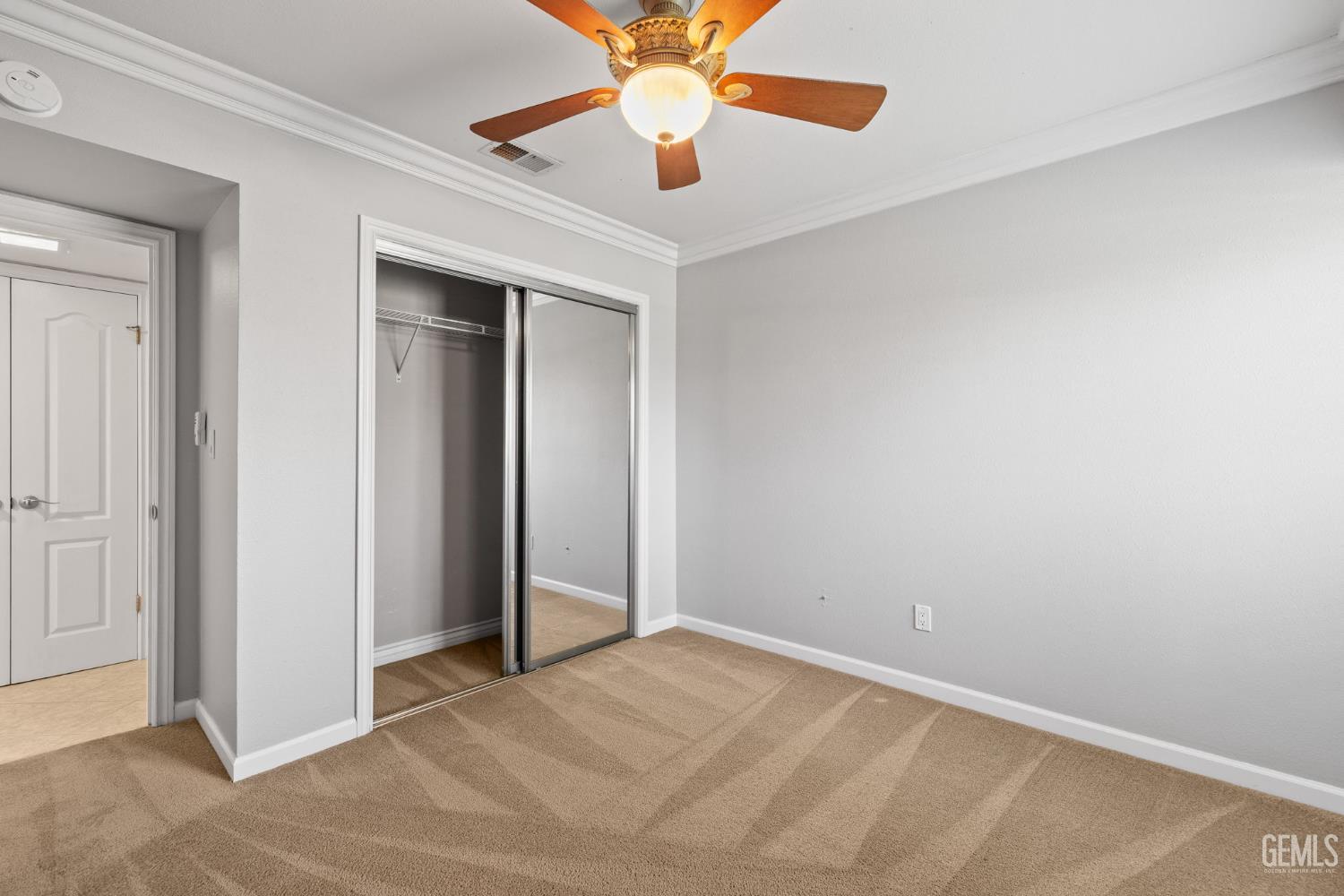 Undisclosed Address Bakersfield, CA 93309 - Photo 36 of 42 an empty room with closet and a chandelier fan
