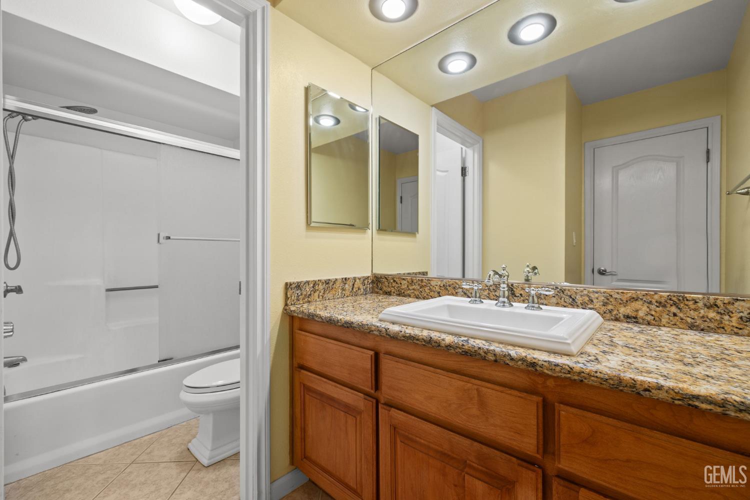 Undisclosed Address Bakersfield, CA 93309 - Photo 37 of 42 a bathroom with a granite countertop sink toilet and shower