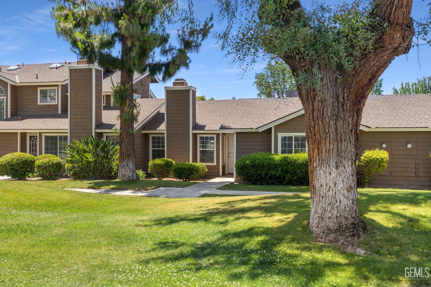 Undisclosed Address Bakersfield, CA 93309 - Photo 4 of 42 a view of a house with a tree in a yard