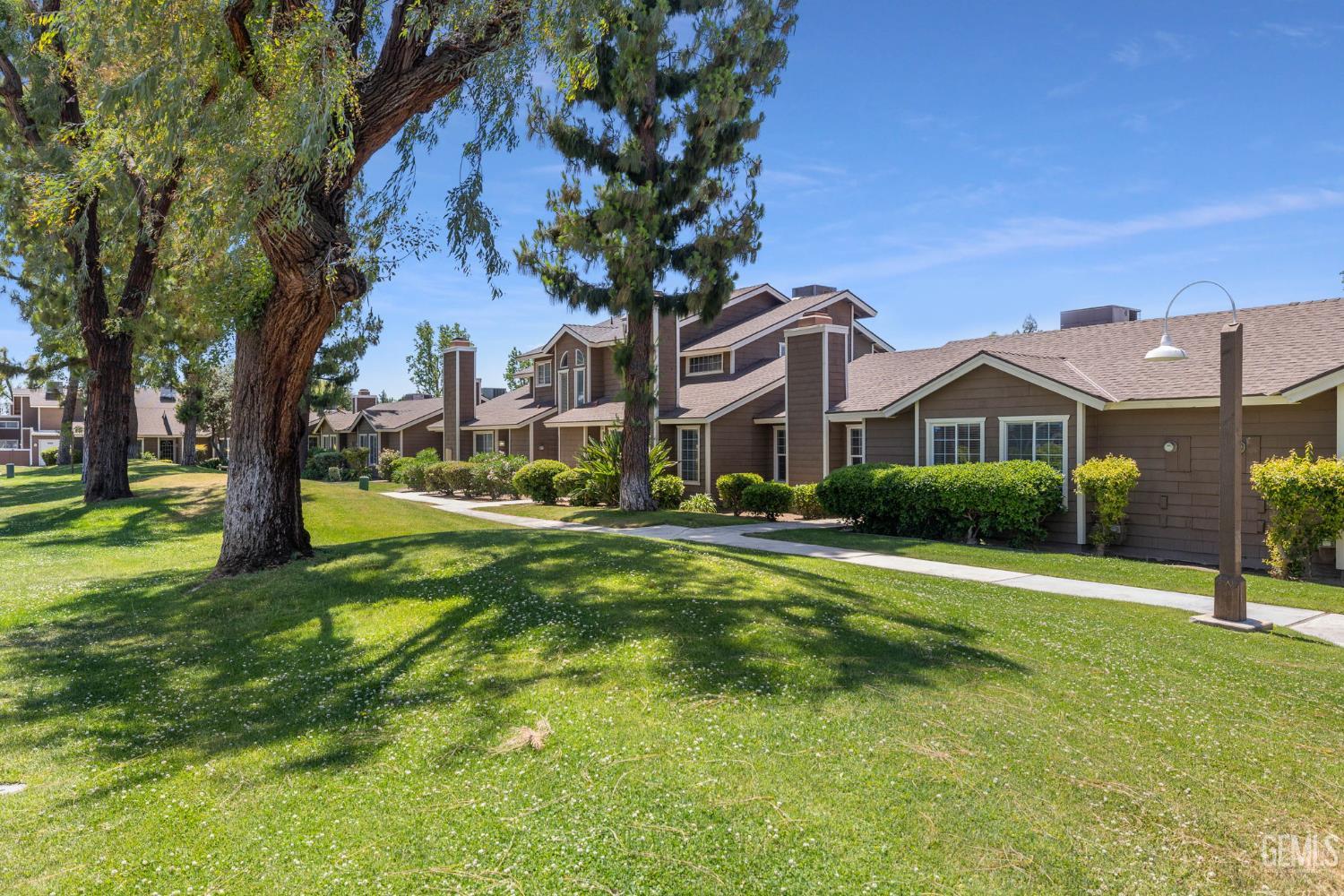 Undisclosed Address Bakersfield, CA 93309 - Photo 5 of 42 a front view of house with yard and green space