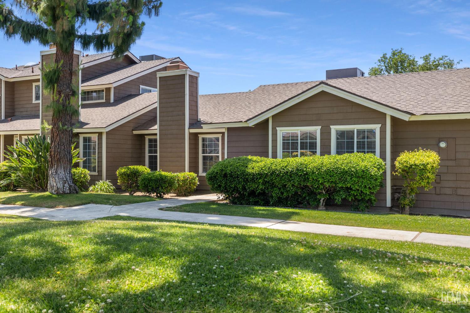 Undisclosed Address Bakersfield, CA 93309 - Photo 6 of 42 a front view of a house with a yard