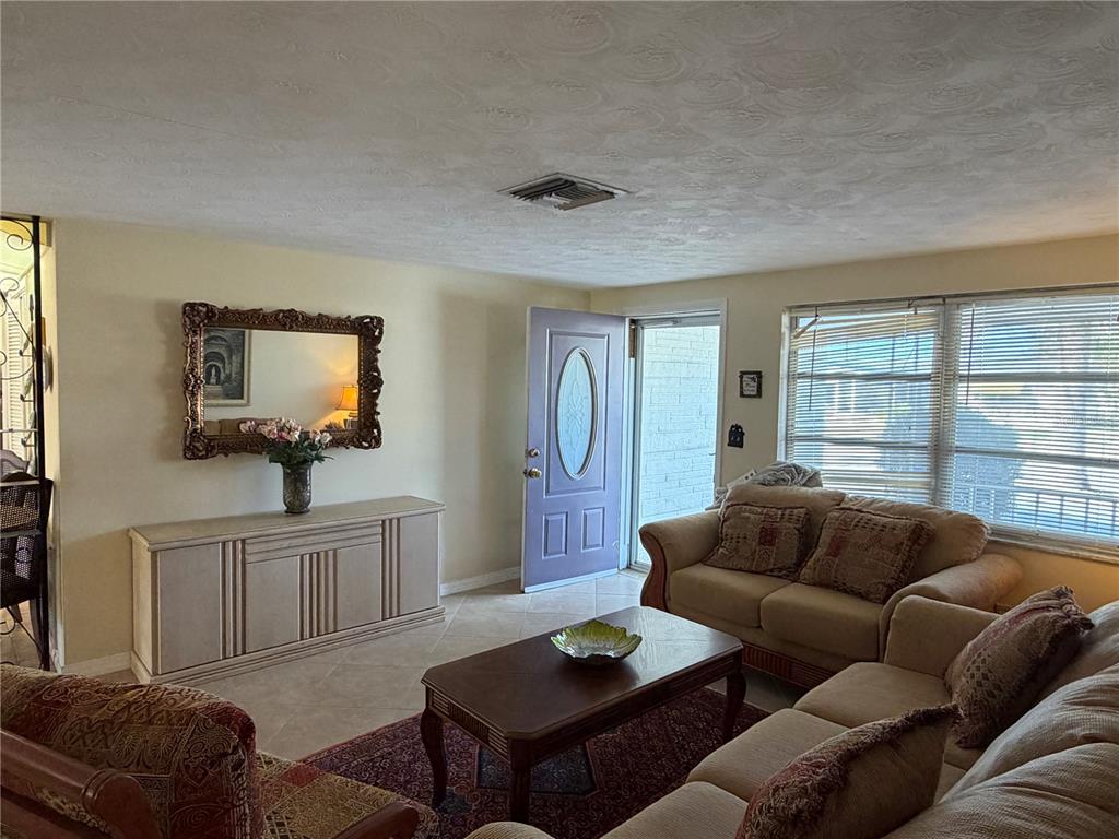3914 Carioca Road Holiday, FL 34691 - Photo 6 of 23 a living room with furniture a window and a flat screen tv