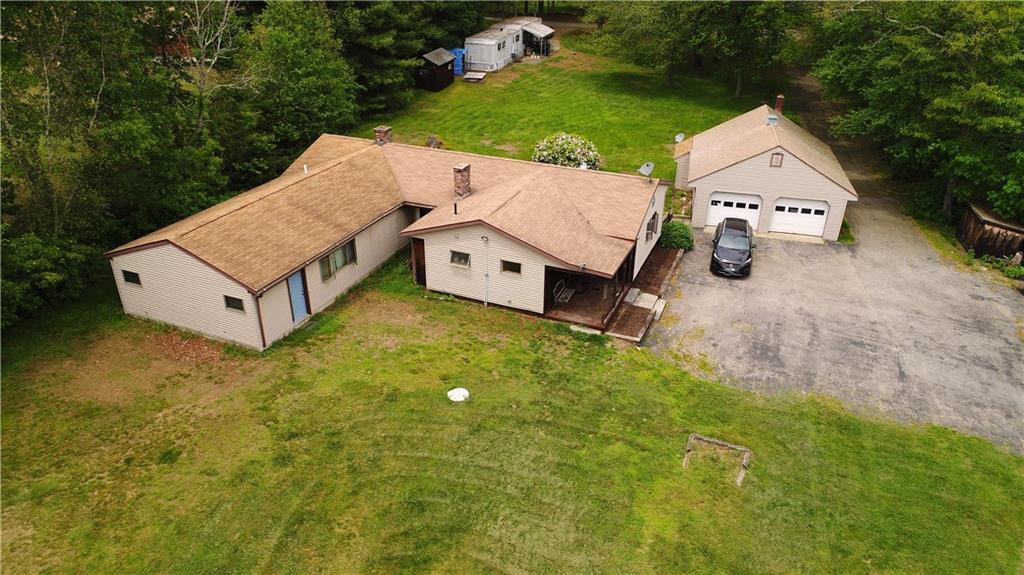an aerial view of a house with garden space and street view