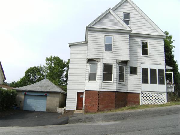 a front view of a house with garage