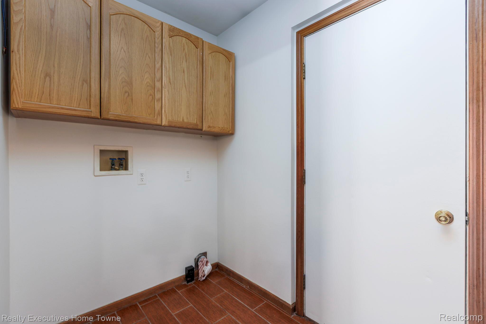 1041 Mackie Road Almont, MI 48003 - Photo 33 of 56 Laundry area with cabinet space, wood finish floors, and washer hookup