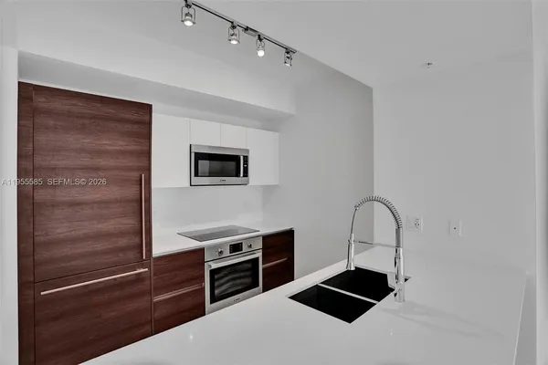 a kitchen with stainless steel appliances a refrigerator and a stove